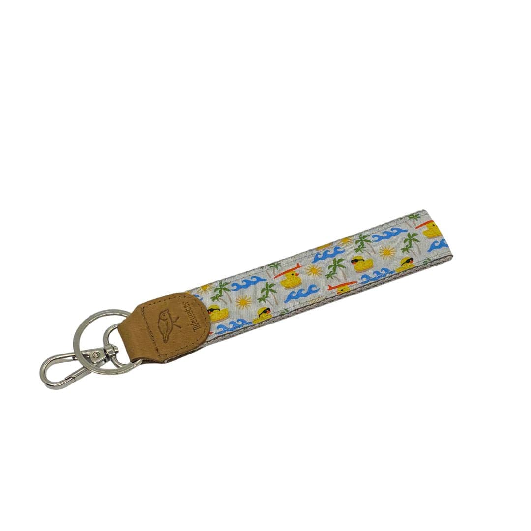 Colorful keychain featuring a fun beach-themed design with ducks, waves, and palm trees, perfect for summer vibes.