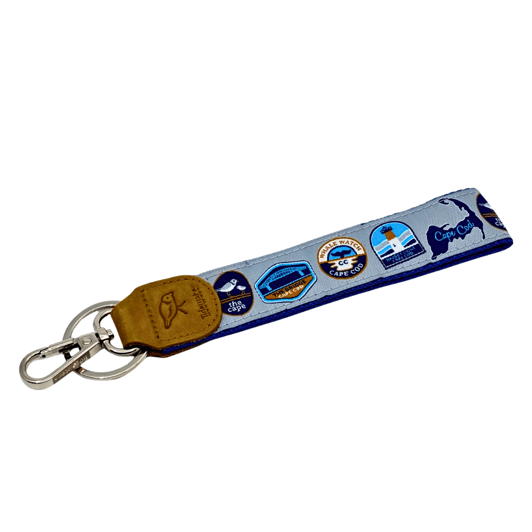 Keychain with colorful designs on a blue strap against a white background