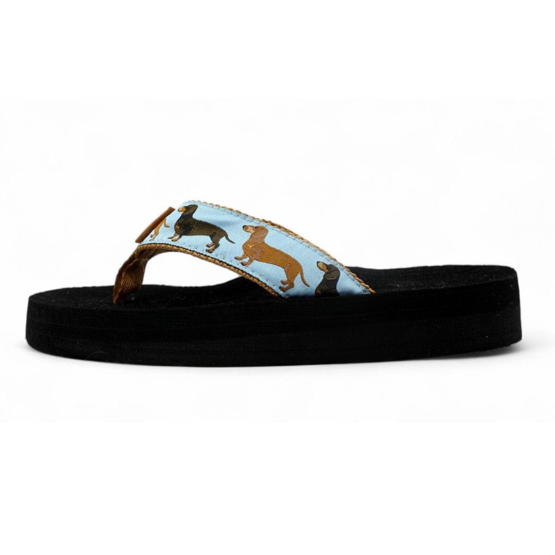 Comfortable flip-flop featuring a playful dachshund pattern on a light blue strap and a black sole.