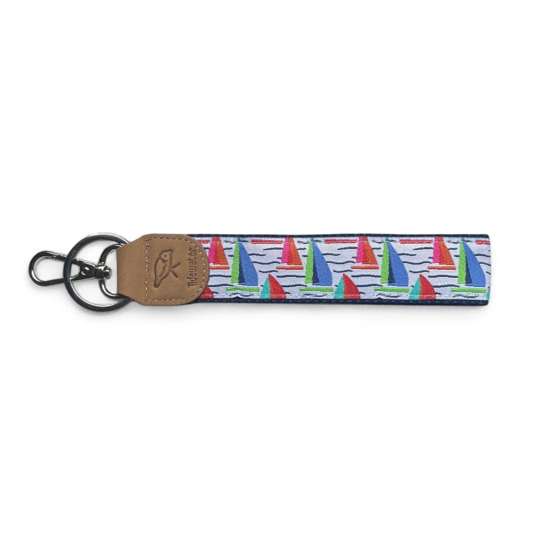 Colorful keychain featuring a nautical sailboat design with red and green sails on a blue background.