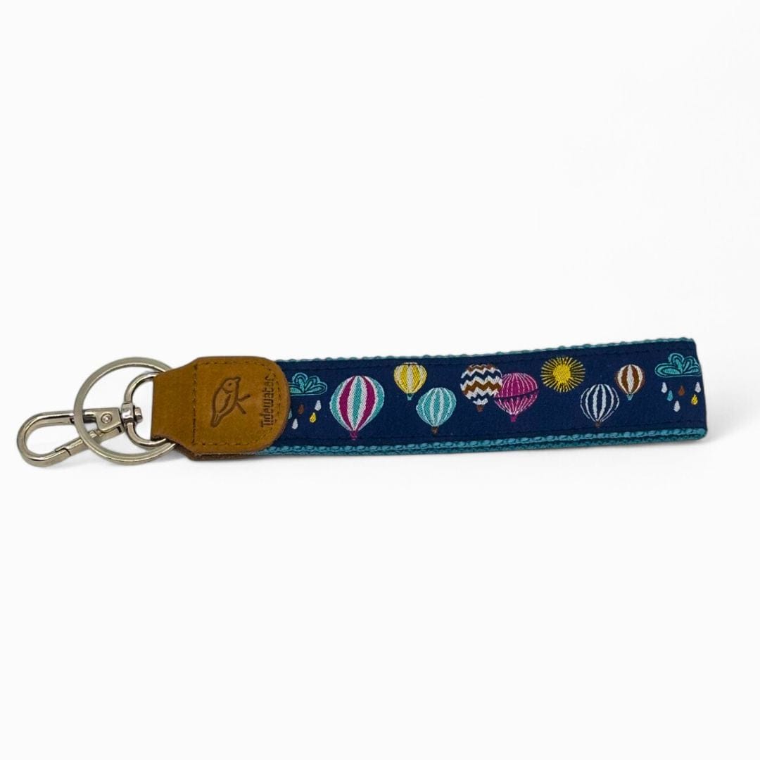 Keychain with colorful hot air balloon design on a blue strap against a white background