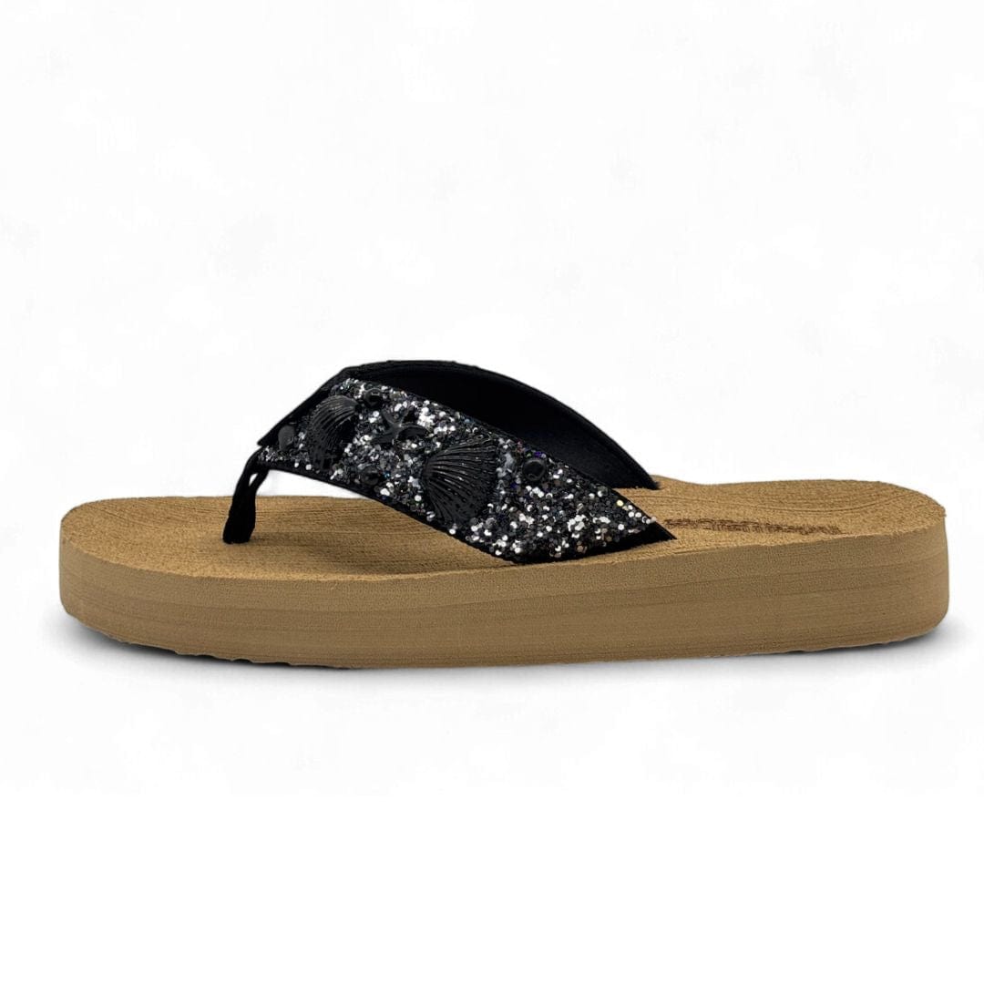Flip-flop sandal with cork sole and black glittery strap on a white background