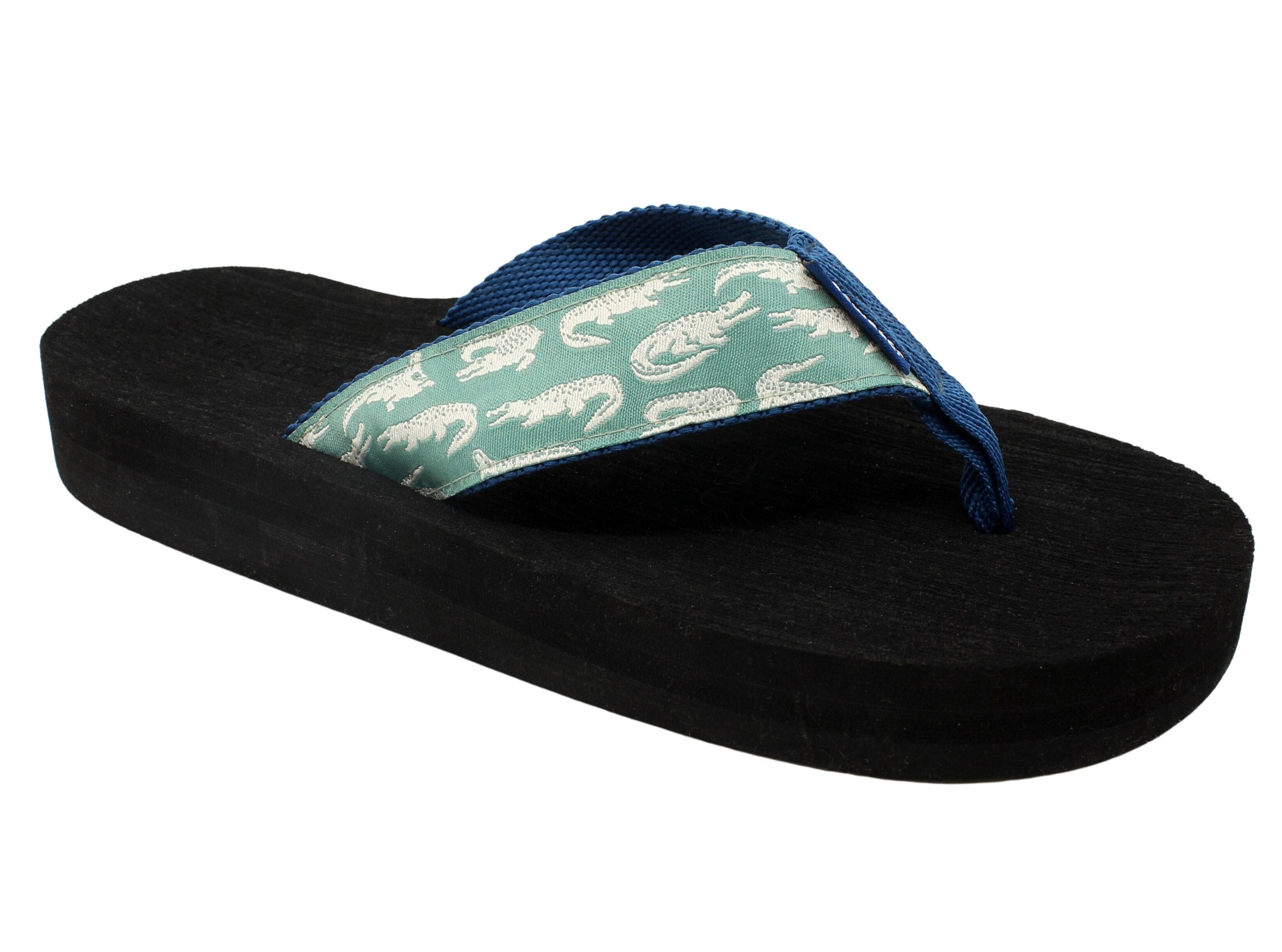 Casual black sandal with a soft green and white alligator-patterned strap and a sturdy black sole.