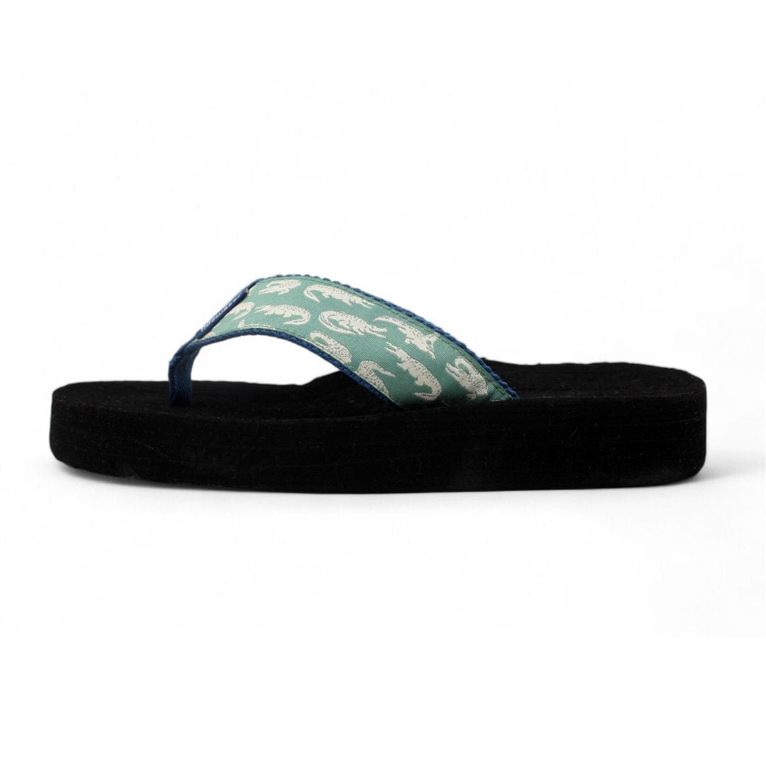 Lightweight flip-flop featuring a green alligator pattern strap and a black foam sole, perfect for casual summer wear.