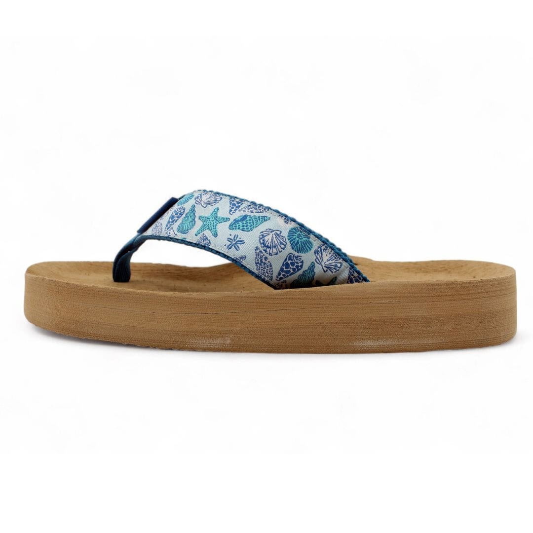 Blue Shells flip-flops featuring a seashell print strap and a comfortable platform sole, perfect for beach outings.