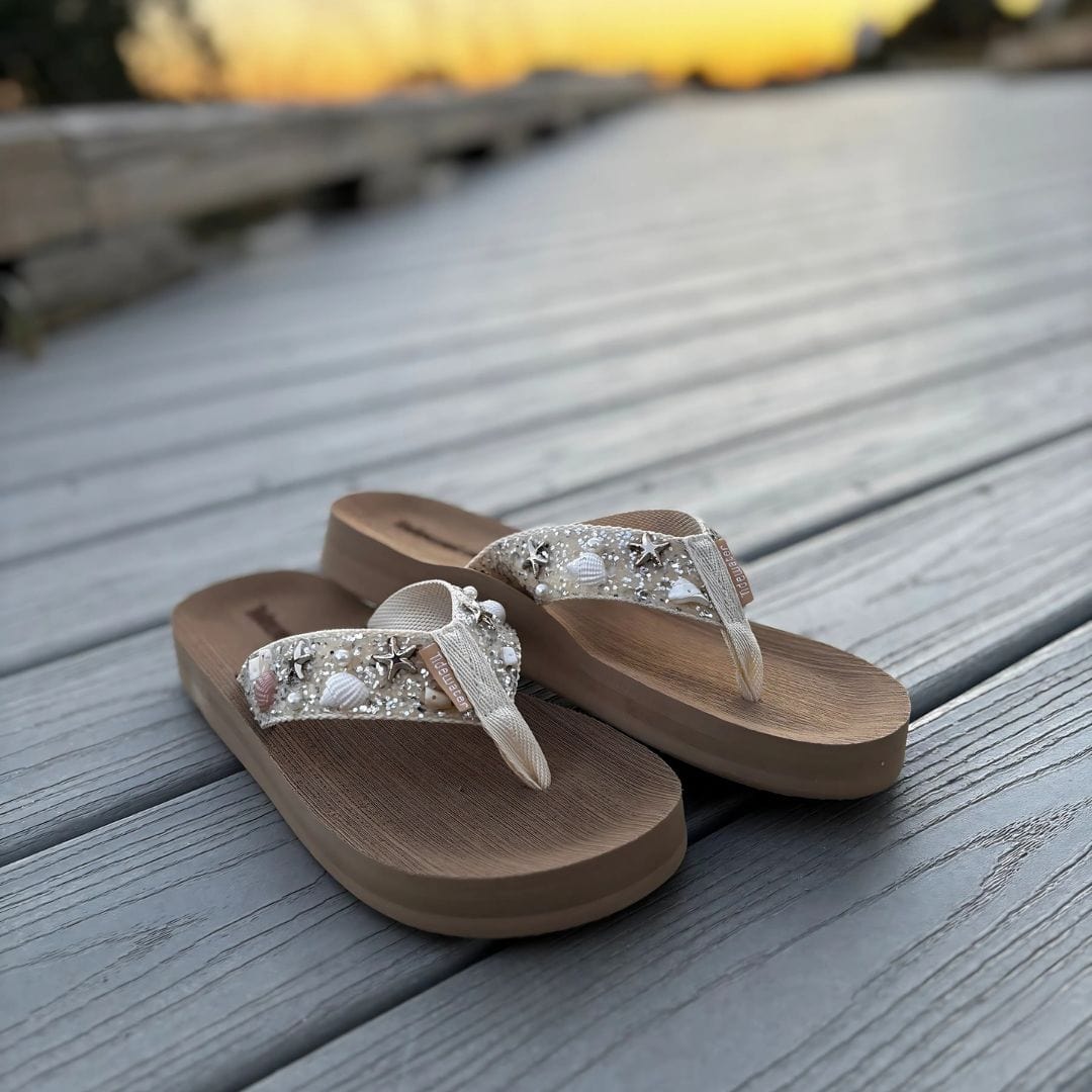 Elegant flip-flops adorned with beads and shells, perfect for beach weddings or casual summer outings.