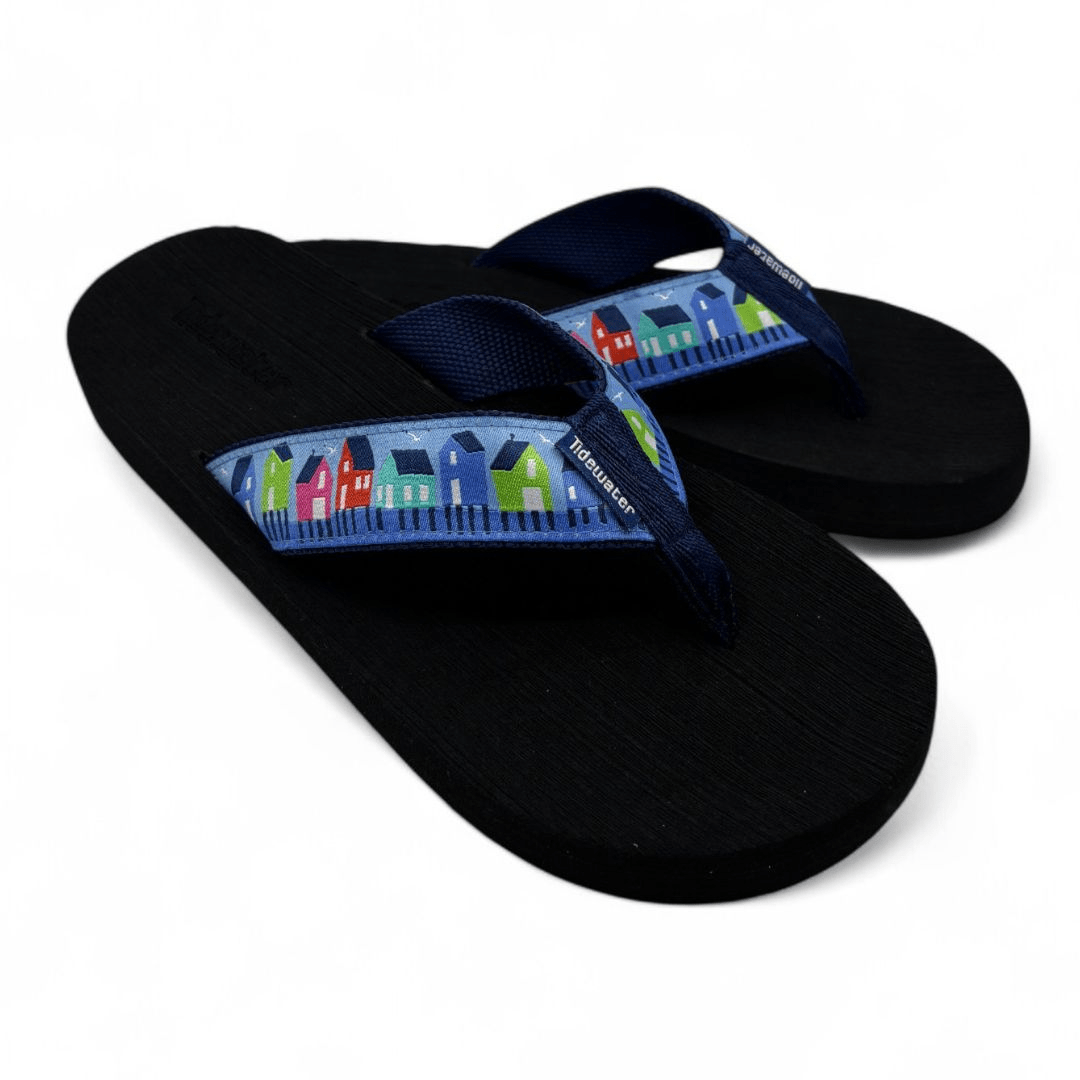 Navy flip-flops featuring a colorful house print on the strap, perfect for beach or casual summer outings.