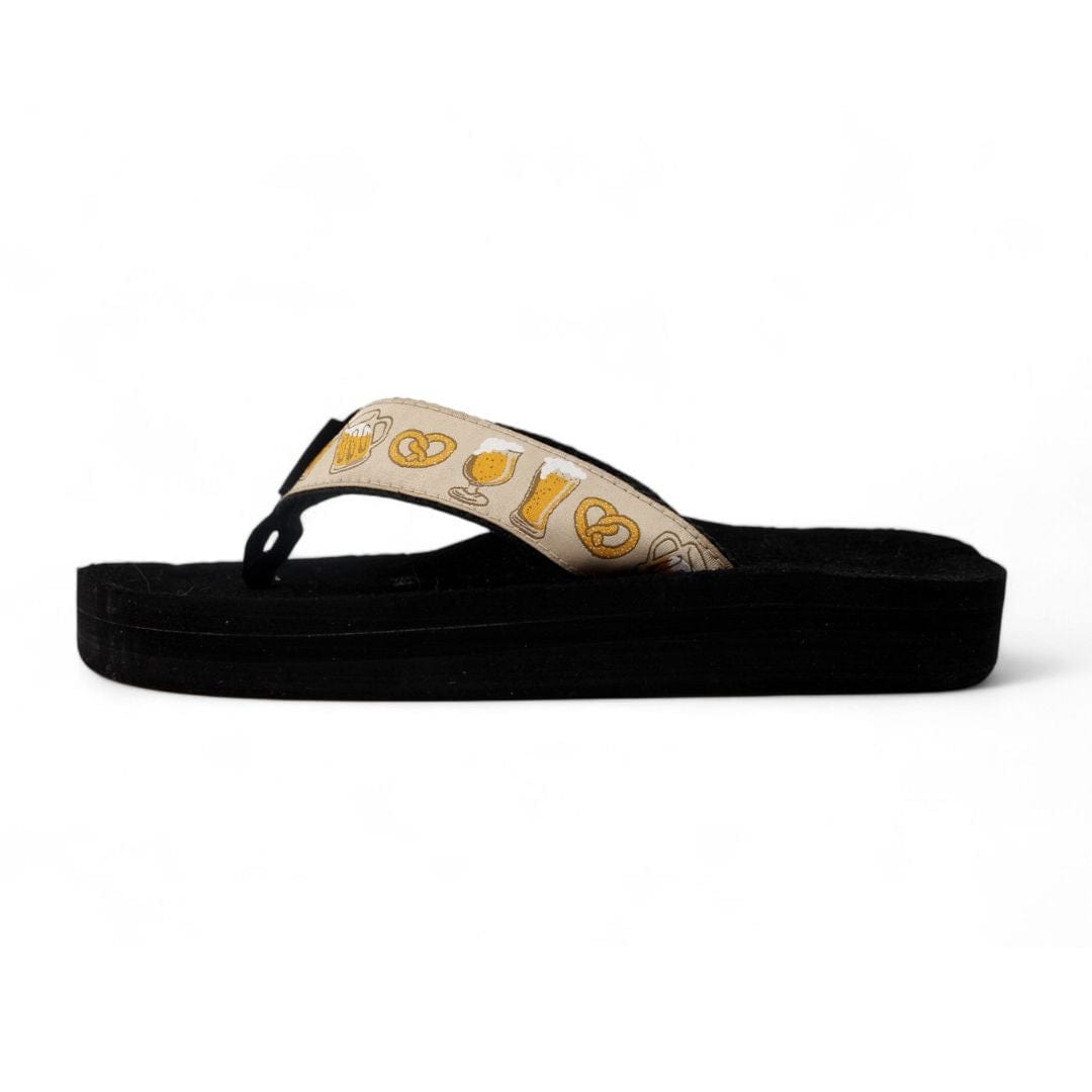 Black sandal with beige strap featuring yellow patterns on a white background