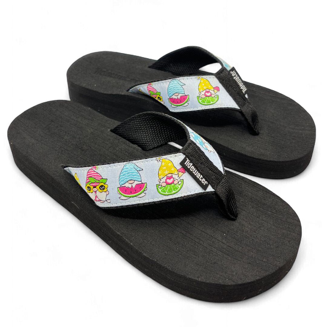 Pair of Tidewater Sunkissed Gnome flip flops with colorful gnome straps on black cushioned soles.