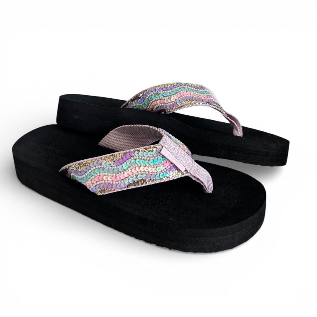 Black flip-flops with colorful sequin straps on a white background