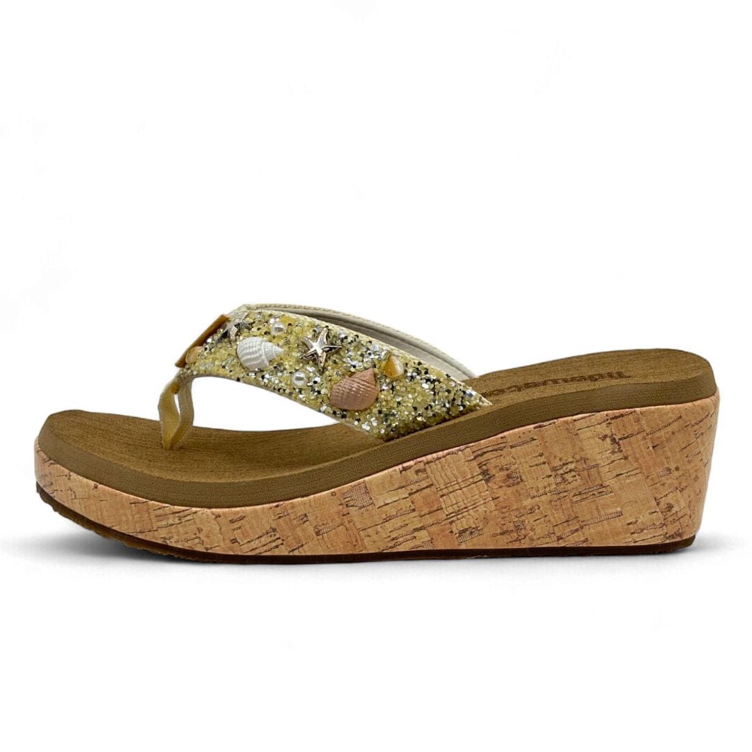 Women’s wedge flip flop with cork sole and beaded seashell embellishments on gold glitter strap